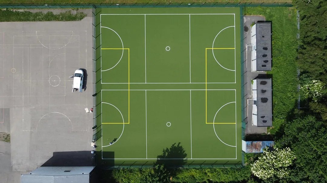 An aerial view of a multi-use games area with line markings