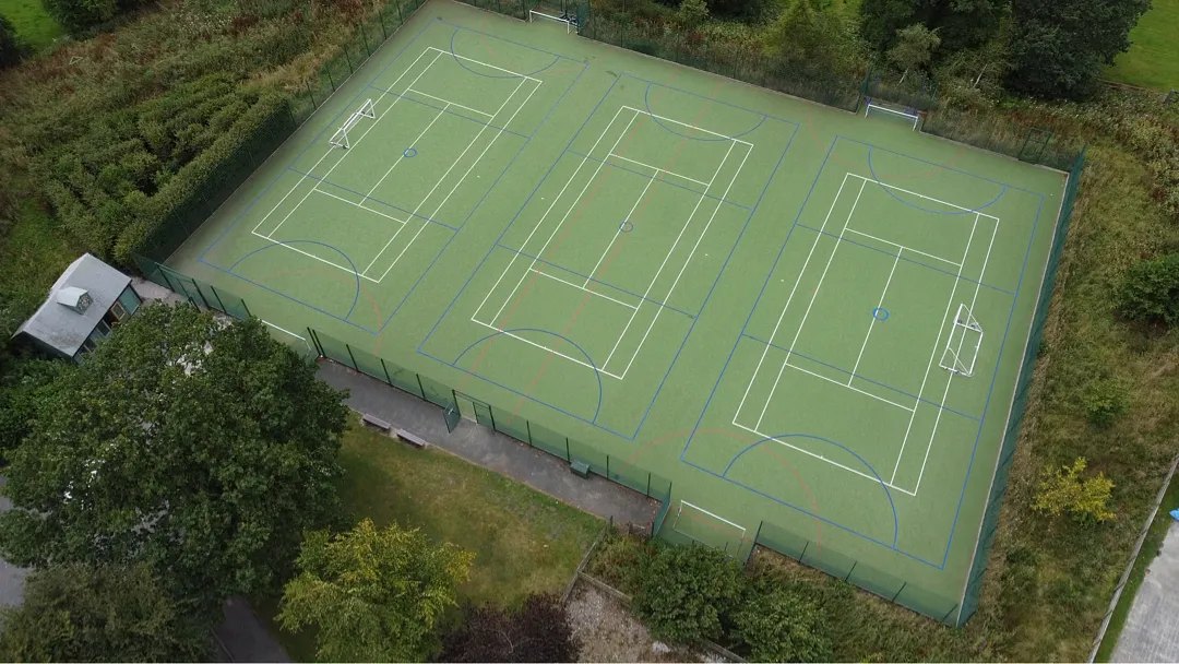 An aerial view of artificial grass tennis courts