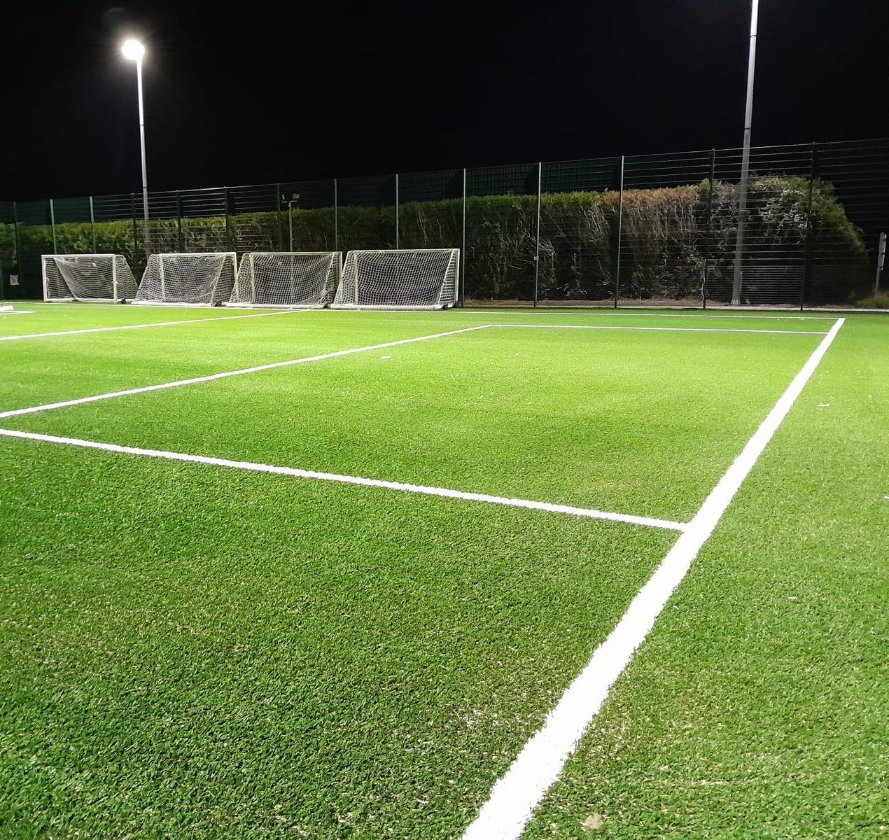 A floodlit 3G pitch with goals
